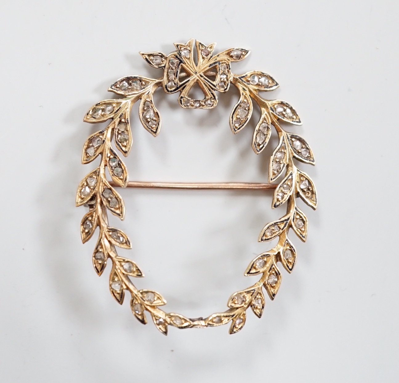 An early 20th century yellow metal and rose cut diamond set oval open work wreath brooch, 40mm, gross weight 5.1 grams.
